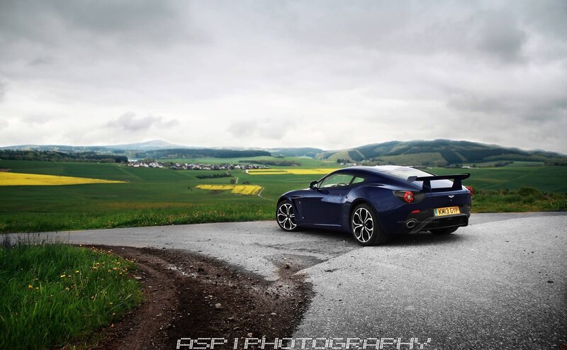 Blue sports car on a country road
