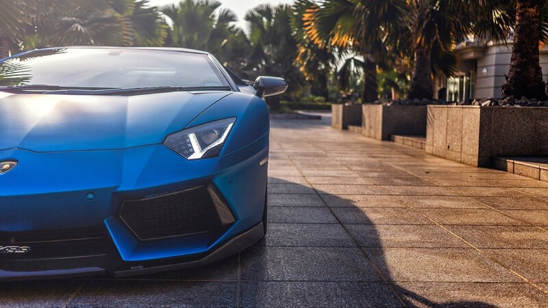 blue sports car on a driveway