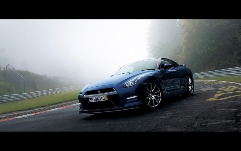 Blue sports car on a foggy track