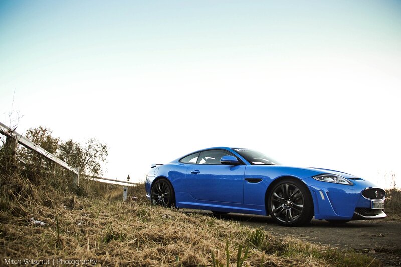 Blue sports car on a hillside