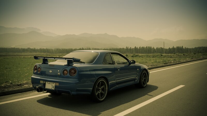 Blue sports car on a road