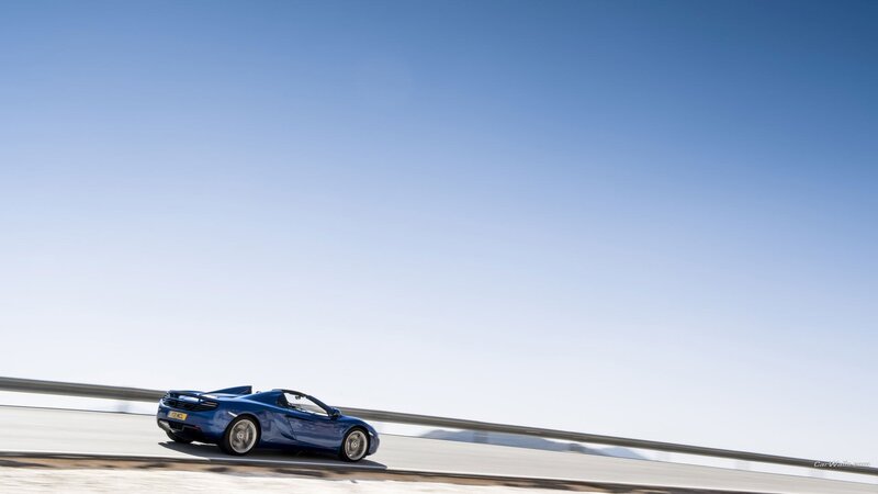 blue sports car on a road