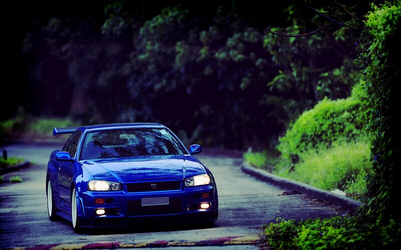 blue sports car on a road