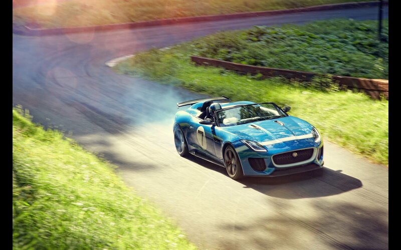 Blue sports car on a winding road