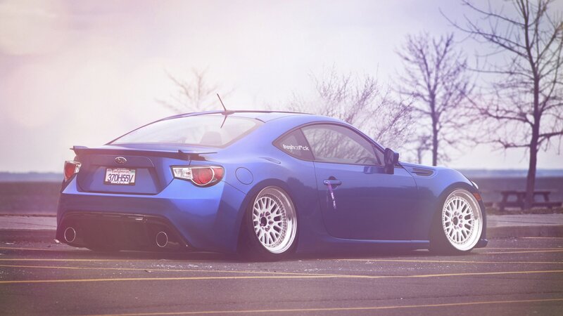 blue sports car on asphalt