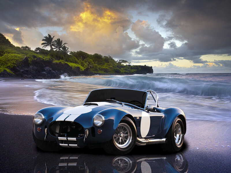 Blue sports car on beach at sunset