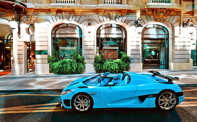 Blue sports car on city street