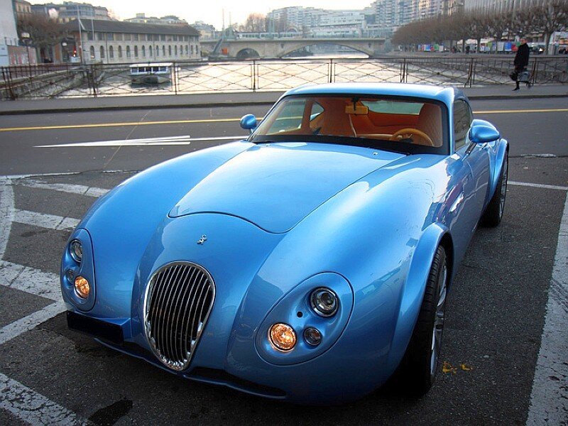Blue sports car on city street