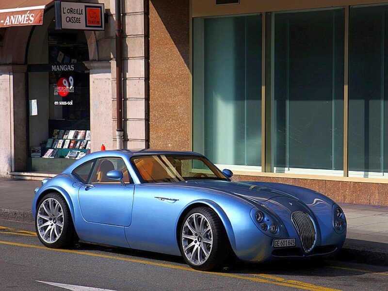 Blue sports car on city street
