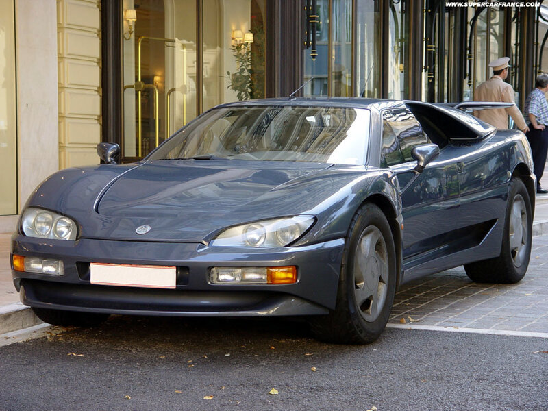 Blue sports car on city street