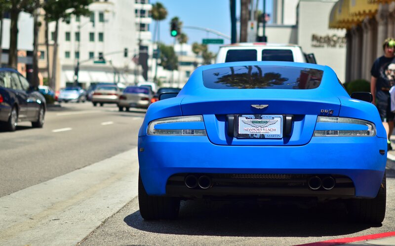 blue sports car on city street