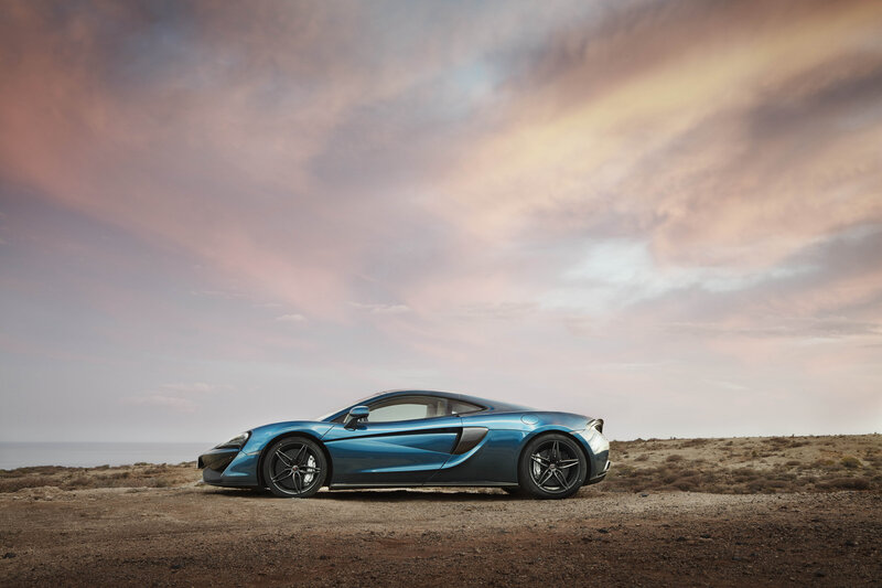 Blue sports car on cliffside