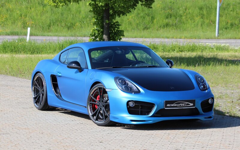 blue sports car on cobblestone