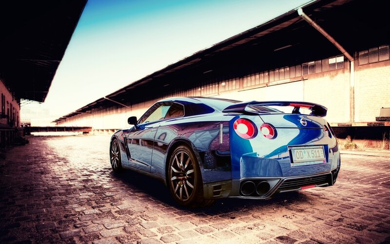 blue sports car on cobblestones