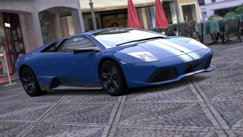 blue sports car on cobblestones