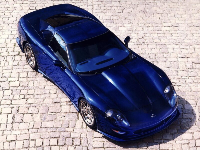 blue sports car on cobblestones