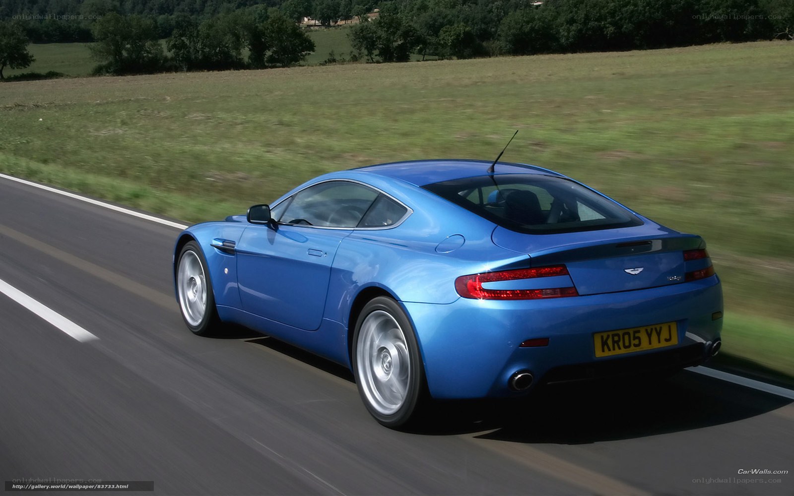 blue sports car on country road