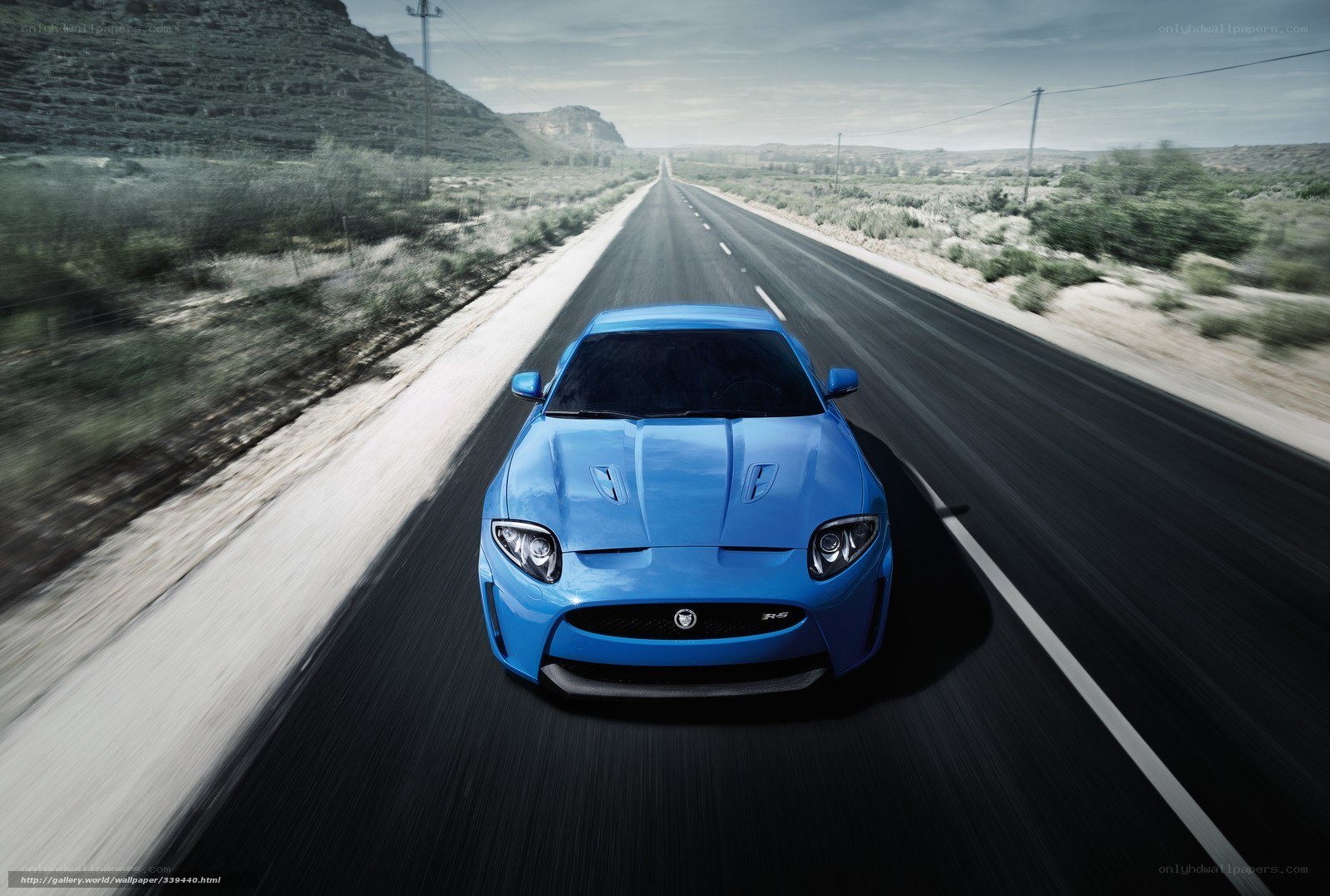 Blue sports car on desert road