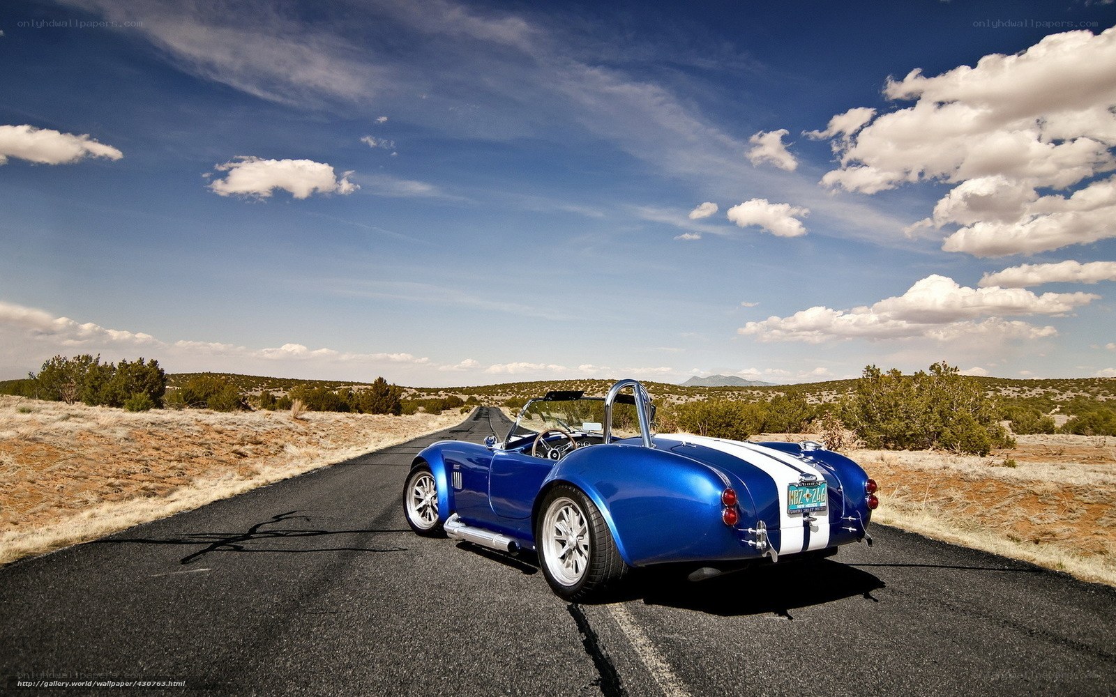 Blue sports car on desert road