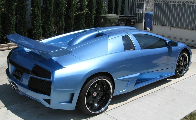 blue sports car on driveway