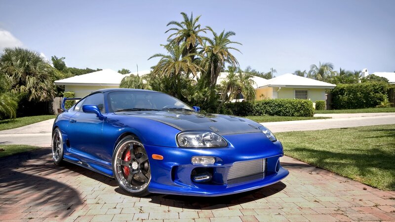 blue sports car on driveway