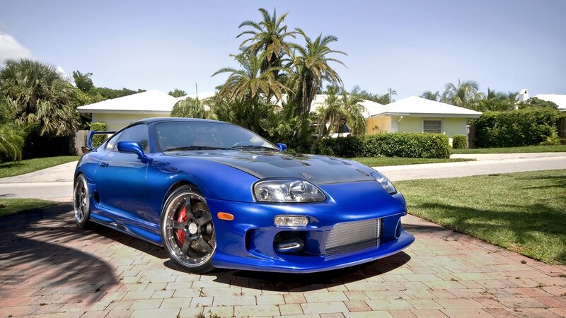 blue sports car on driveway