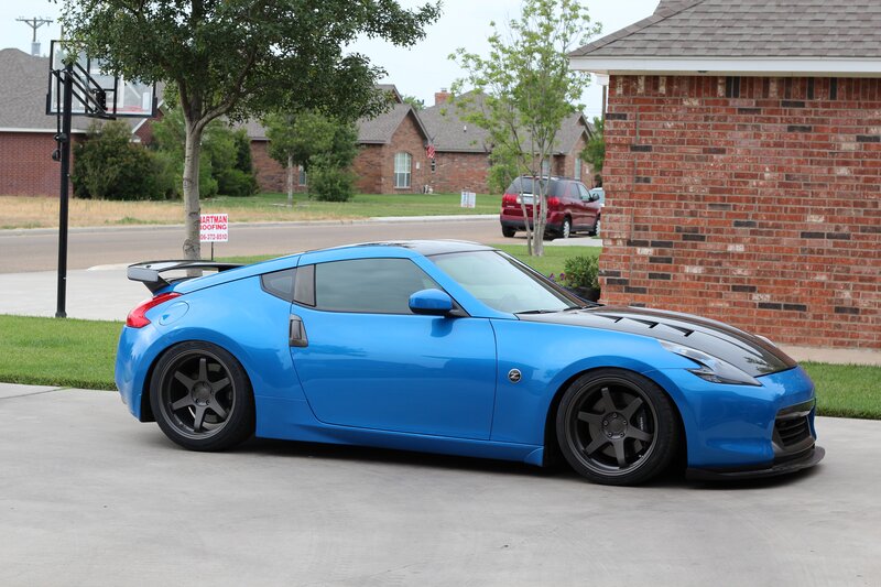 blue sports car on driveway