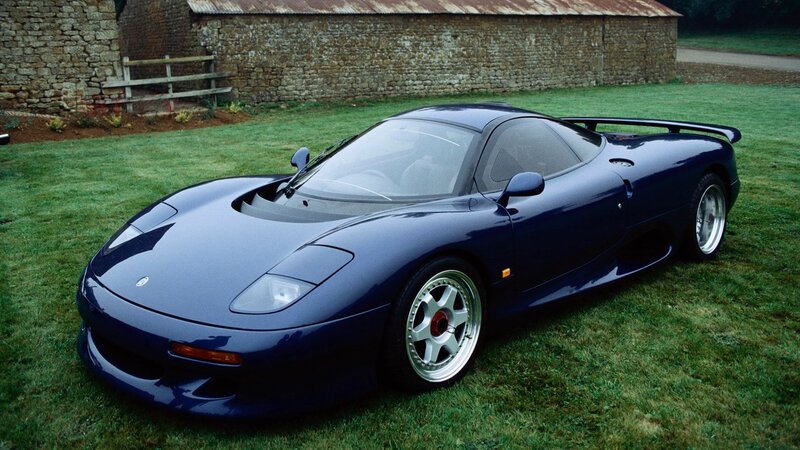 blue sports car on grass