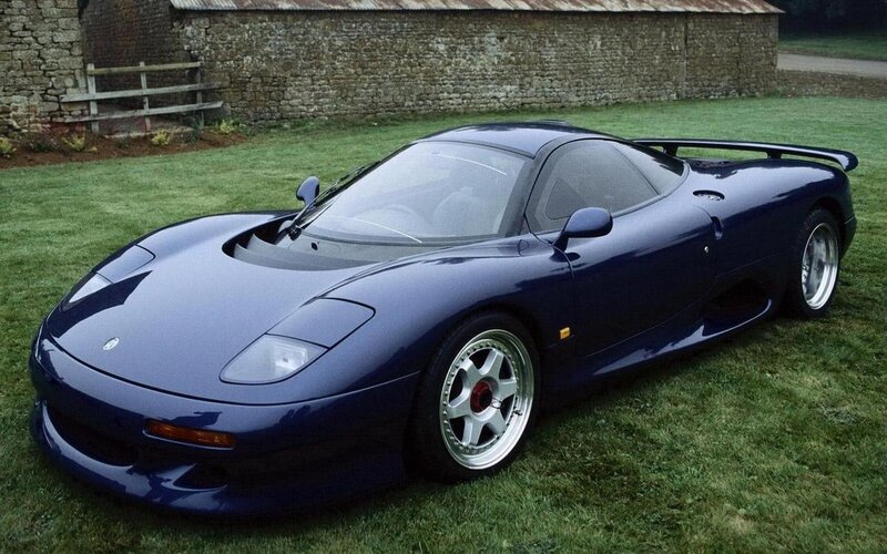 blue sports car on grass