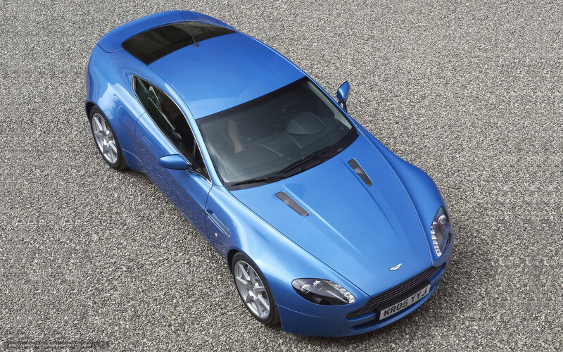 blue sports car on gravel