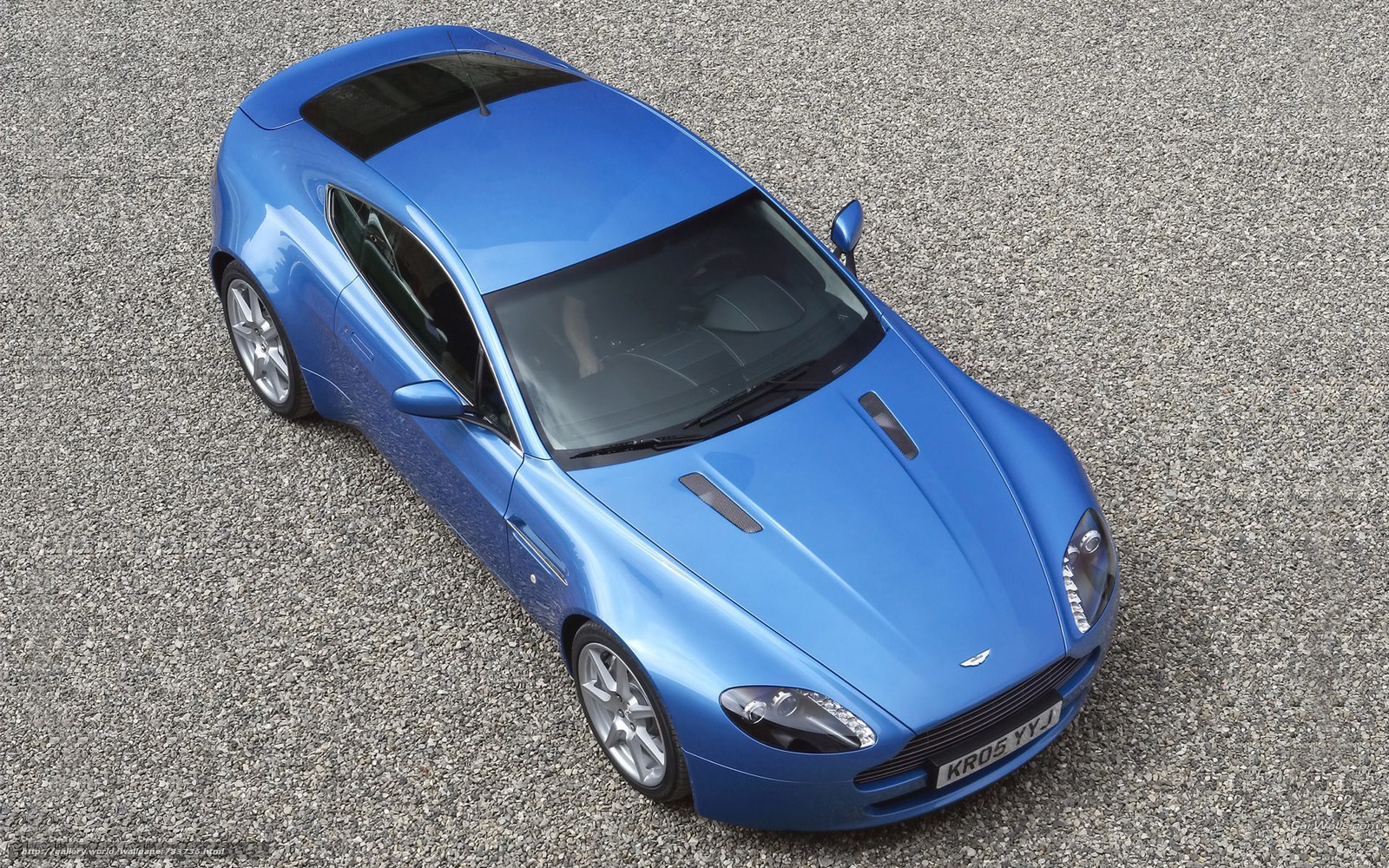 blue sports car on gravel