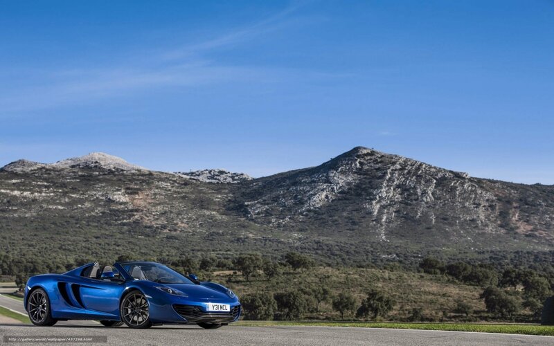 Blue sports car on mountain road