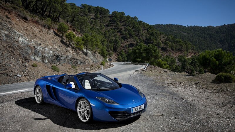 Blue sports car on mountain road