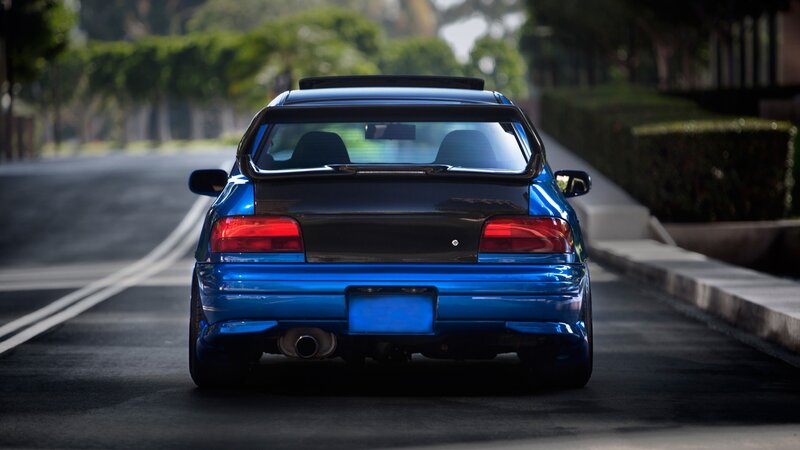 blue sports car on road