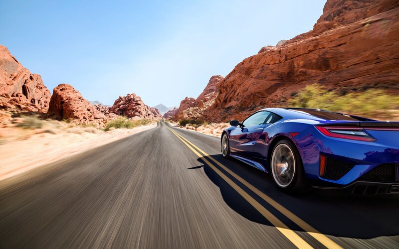 Blue Sports Car on Road — Dynamic, Afternoon, Photograph, Rock Formations