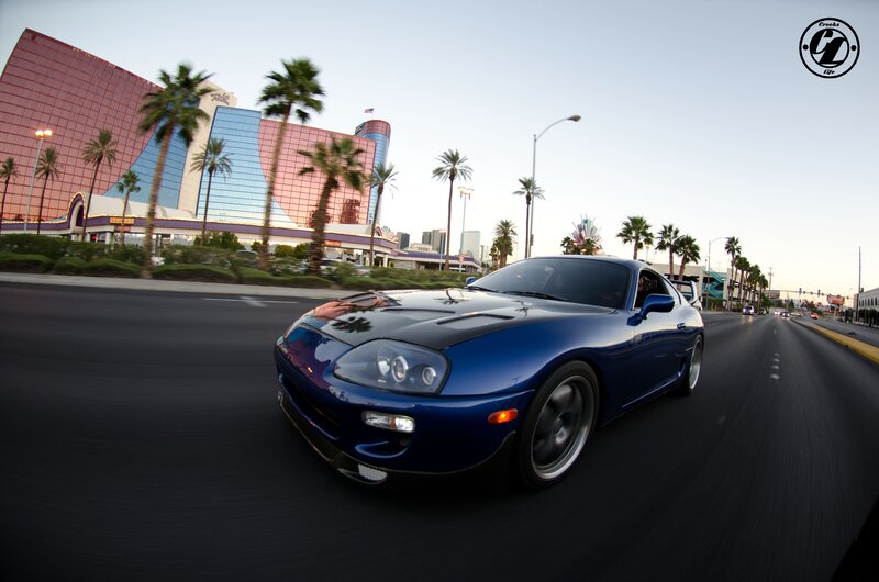 Blue Sports Car on Road — Dynamic, Sunset