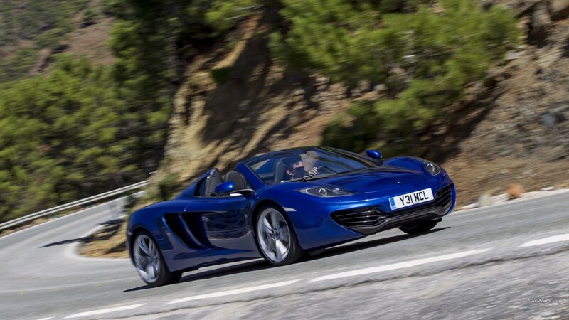 blue sports car on winding road