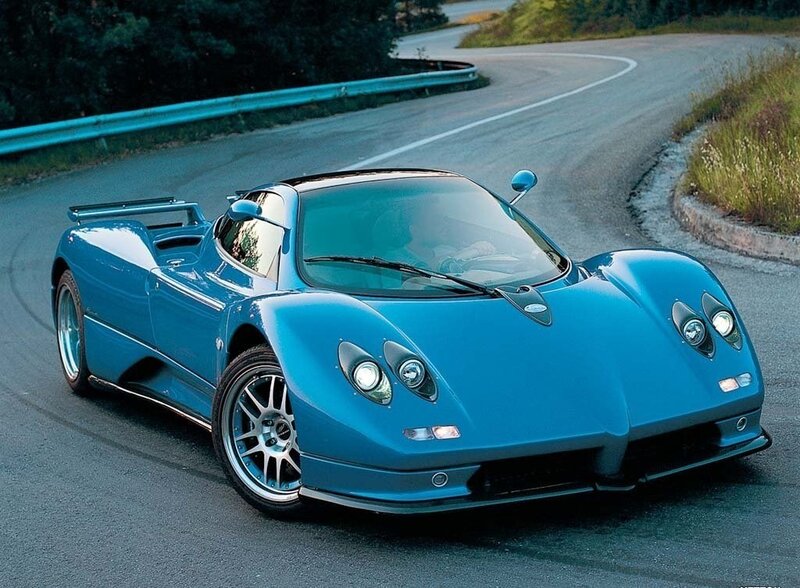 blue sports car on winding road