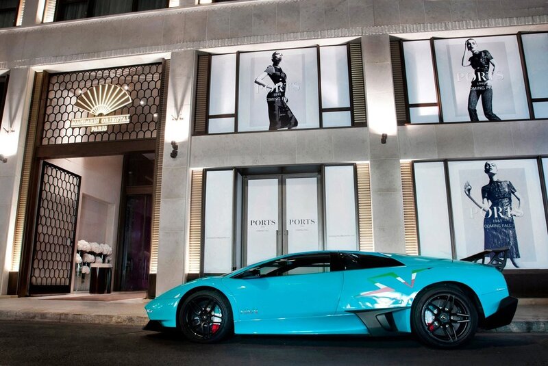 Blue sports car outside luxury store