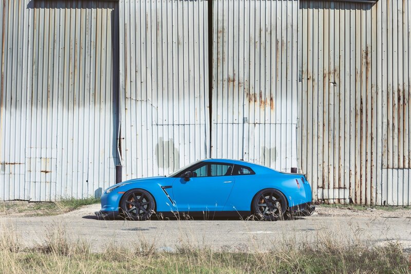 Blue sports car parked outside