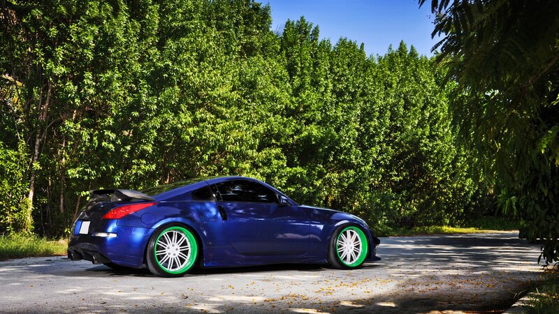 Blue Sports Car — Serene, Afternoon, Photograph, Green Wheels, Trees, Road