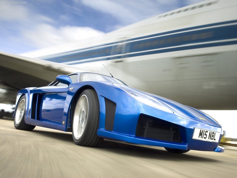 Blue sports car under airplane