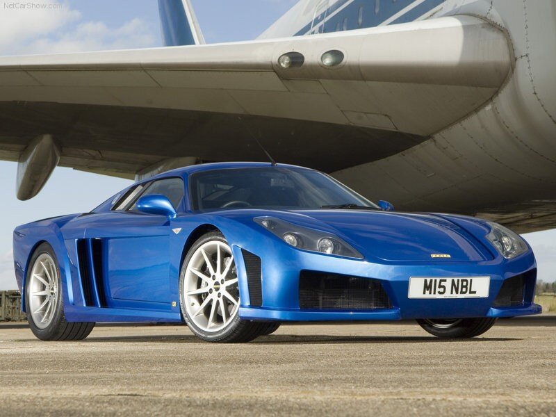 blue sports car under airplane
