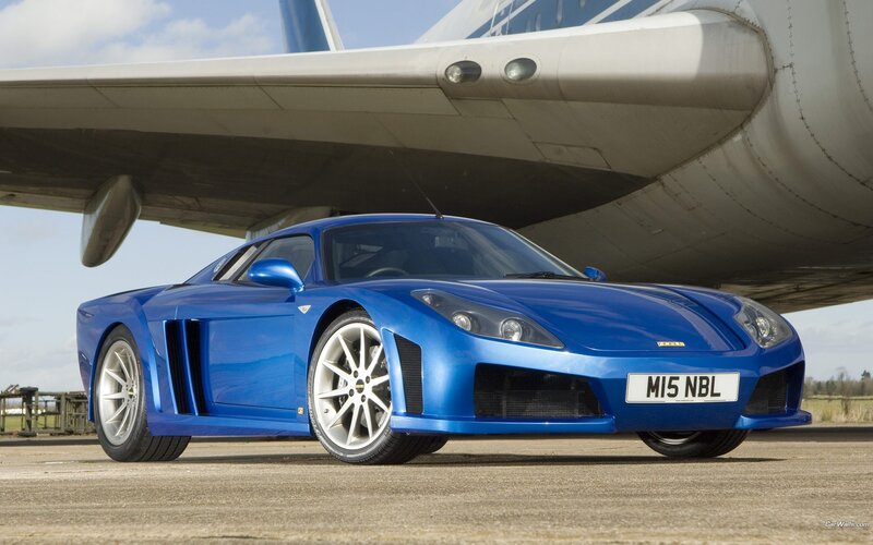blue sports car under airplane