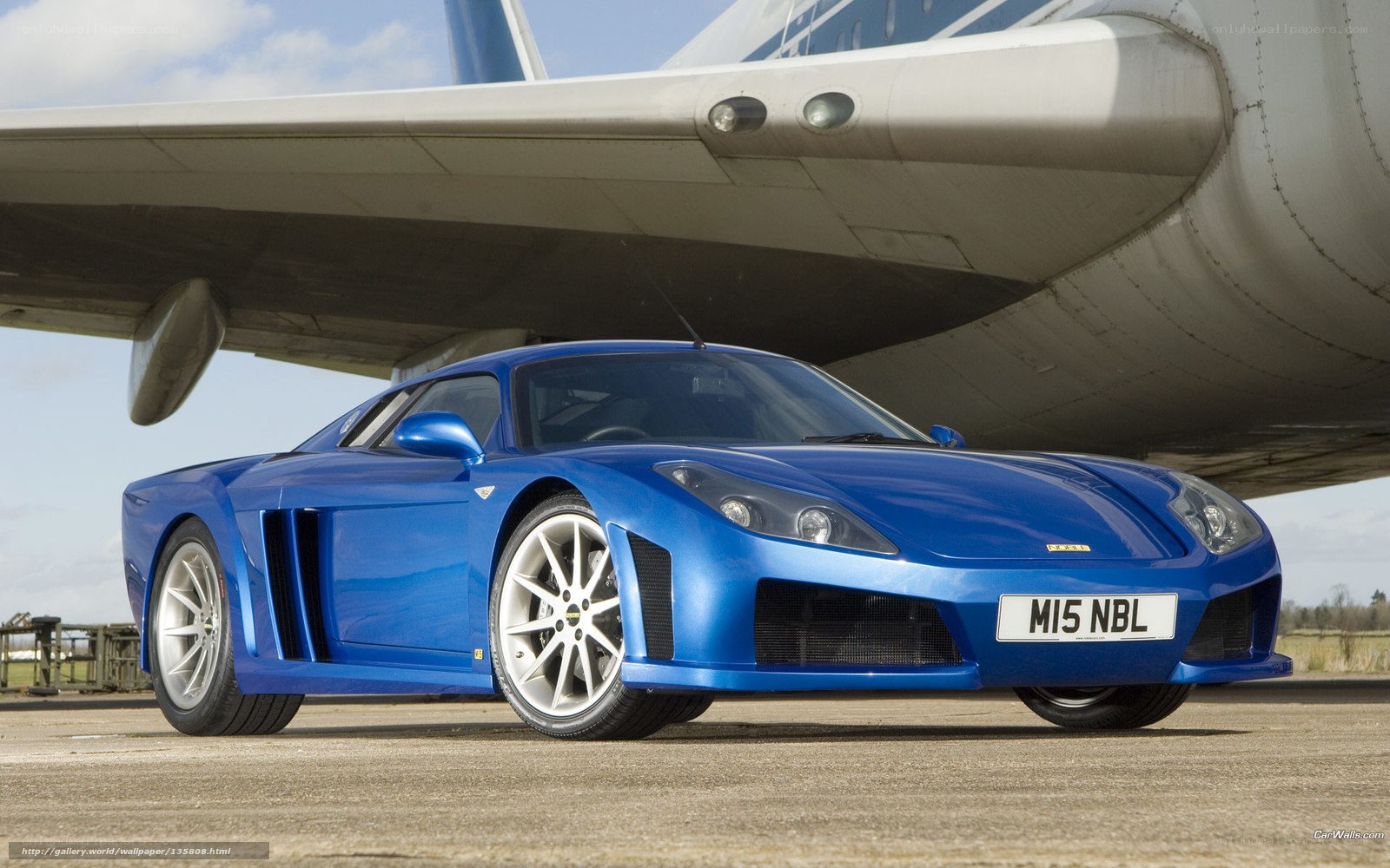 blue sports car under airplane