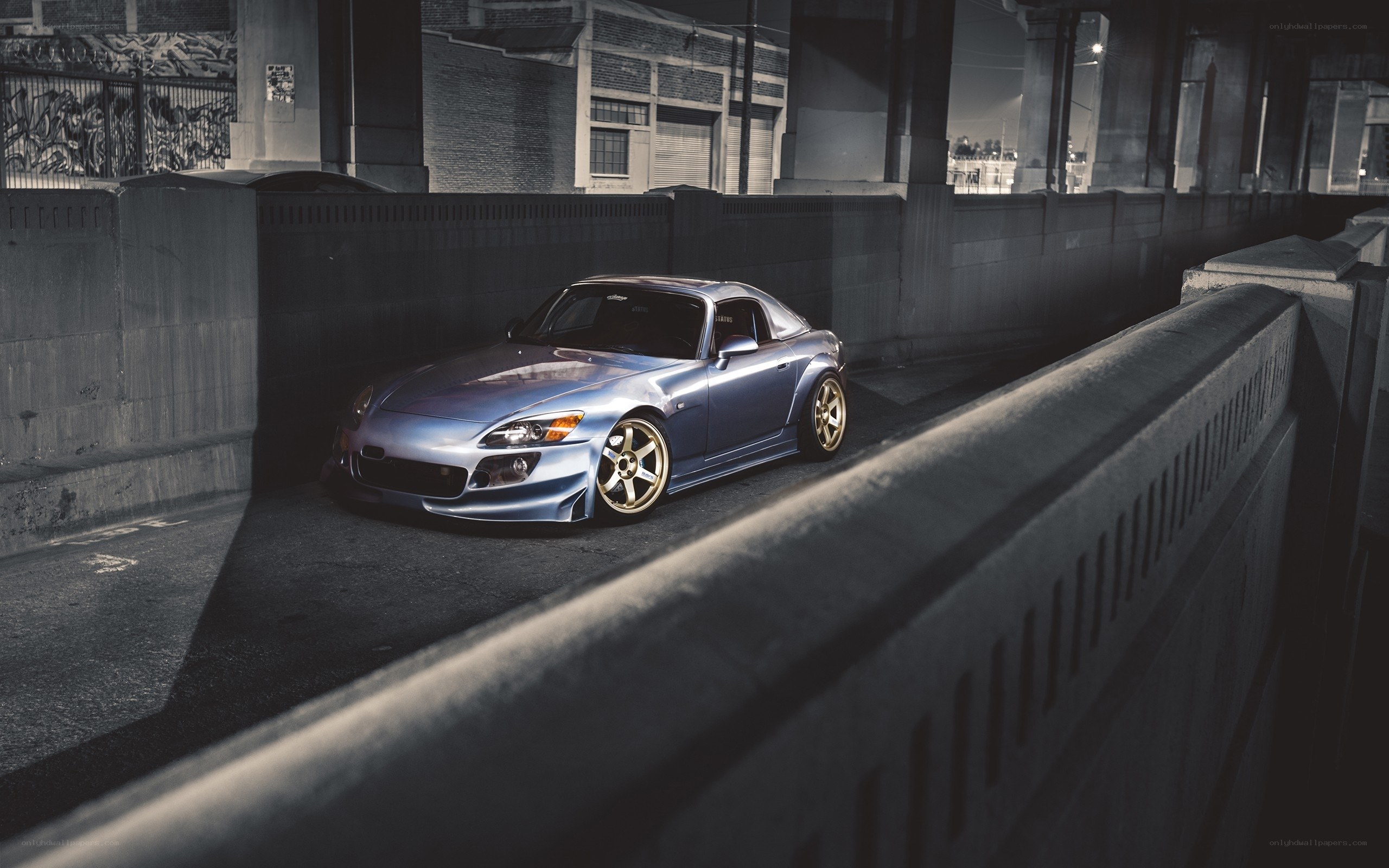 Blue sports car under bridge
