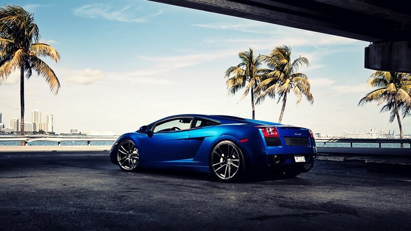 Blue sports car under bridge