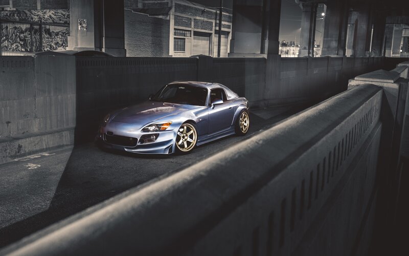 Blue sports car under bridge