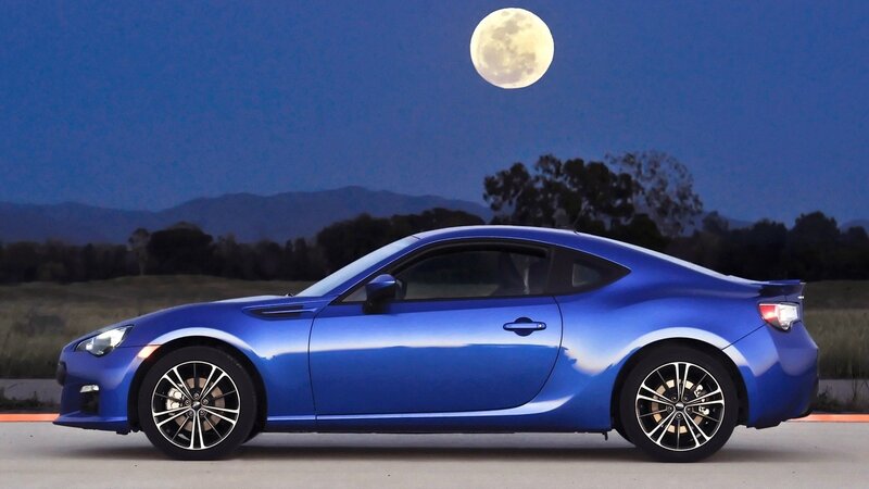 Blue sports car under moonlight