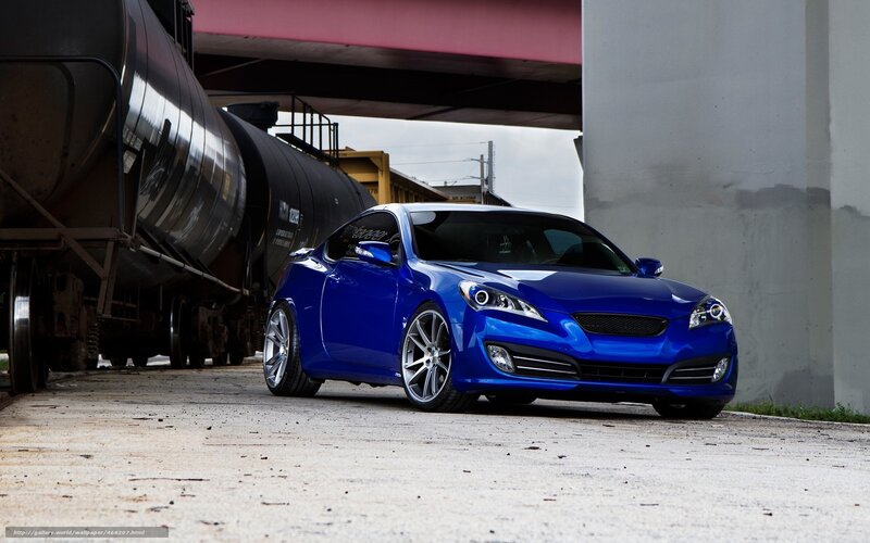 Blue sports car under train bridge